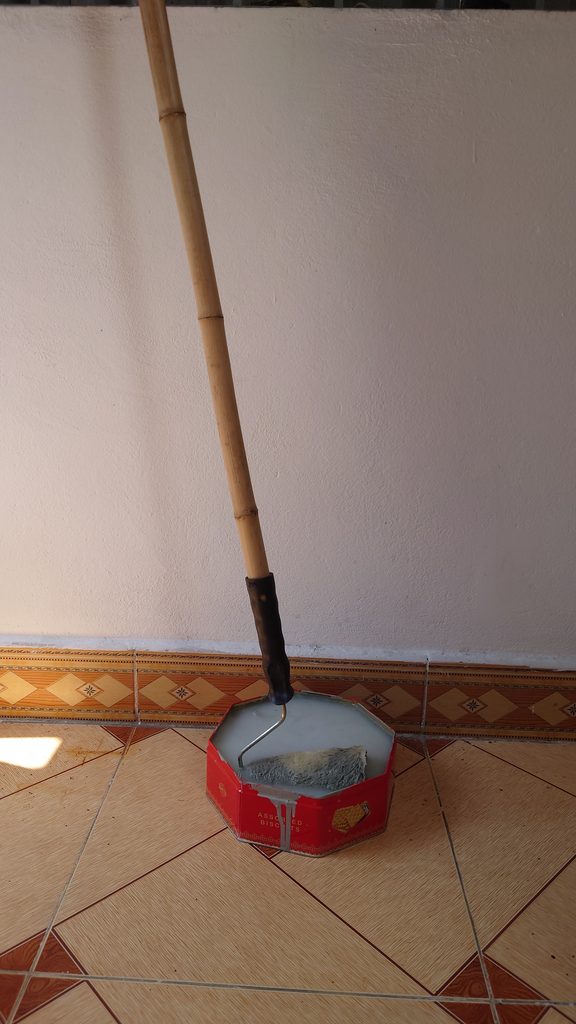 Rulo sơn cắm vào que tre dài để sơn ở vị trí xa, an toàn hơn